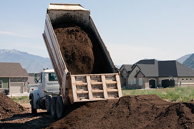 Delivered topsoil prior to spreading by Robert Nelson Construction in Salem, UT.